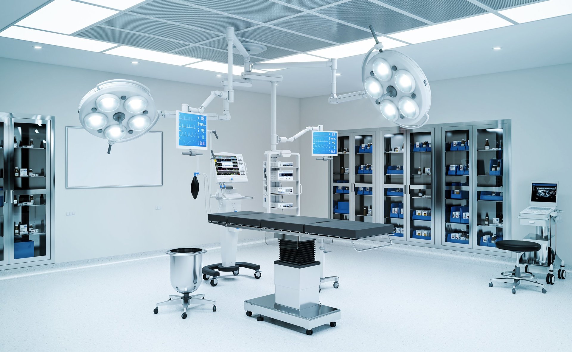 Empty operating room with medical equipment and surgical lights