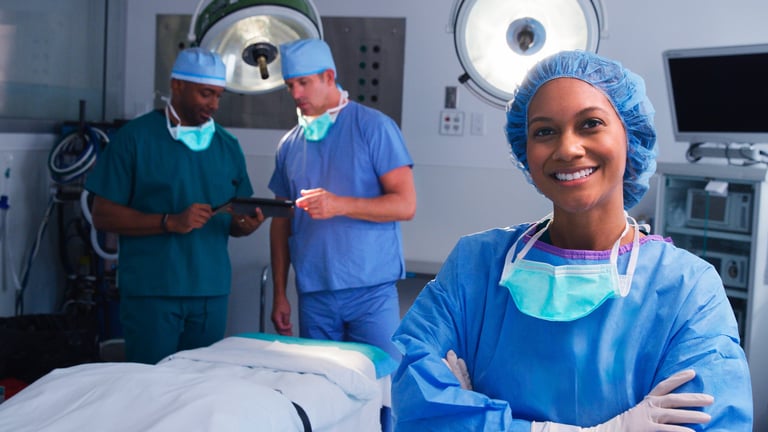 Portrait of female surgeon wearing scrubs in hospital operating theater with surgical lights